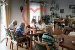 Mehrere alte Menschen Seniorinnen und Senioren essen Mittag in einem Speiseraum eines Pflegeheims