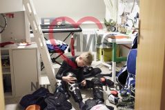 Junge zieht im Kinderzimmer Sportkleidung an